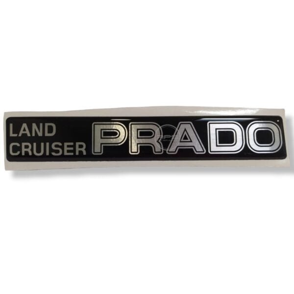 EMBLEMA PLAQUERO PRADO "TOYOTA PRADO-ALUMBRA PLACA"
