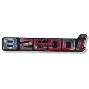 EMBLEMA B2600i (MAZDA B2600) Guarda-Barro